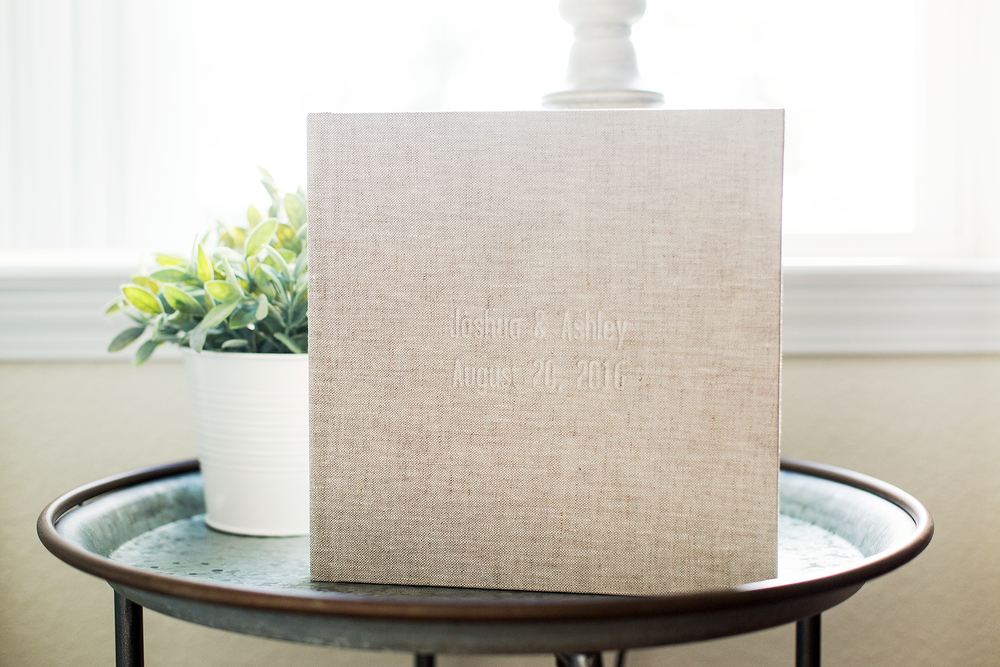 Elegant blind debossing featuring the bride and groom's names and wedding date.
